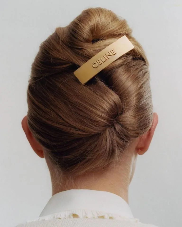 shoulder straight chestnut twist updo shown as a wedding guest hairstyle idea