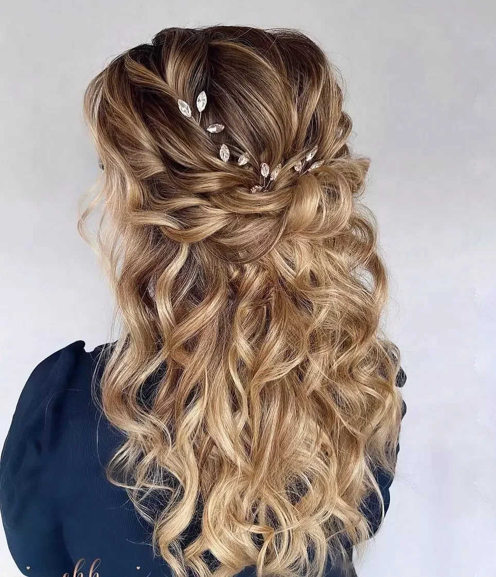 chest wavy brunette ponytail shown as a wedding guest hairstyle idea