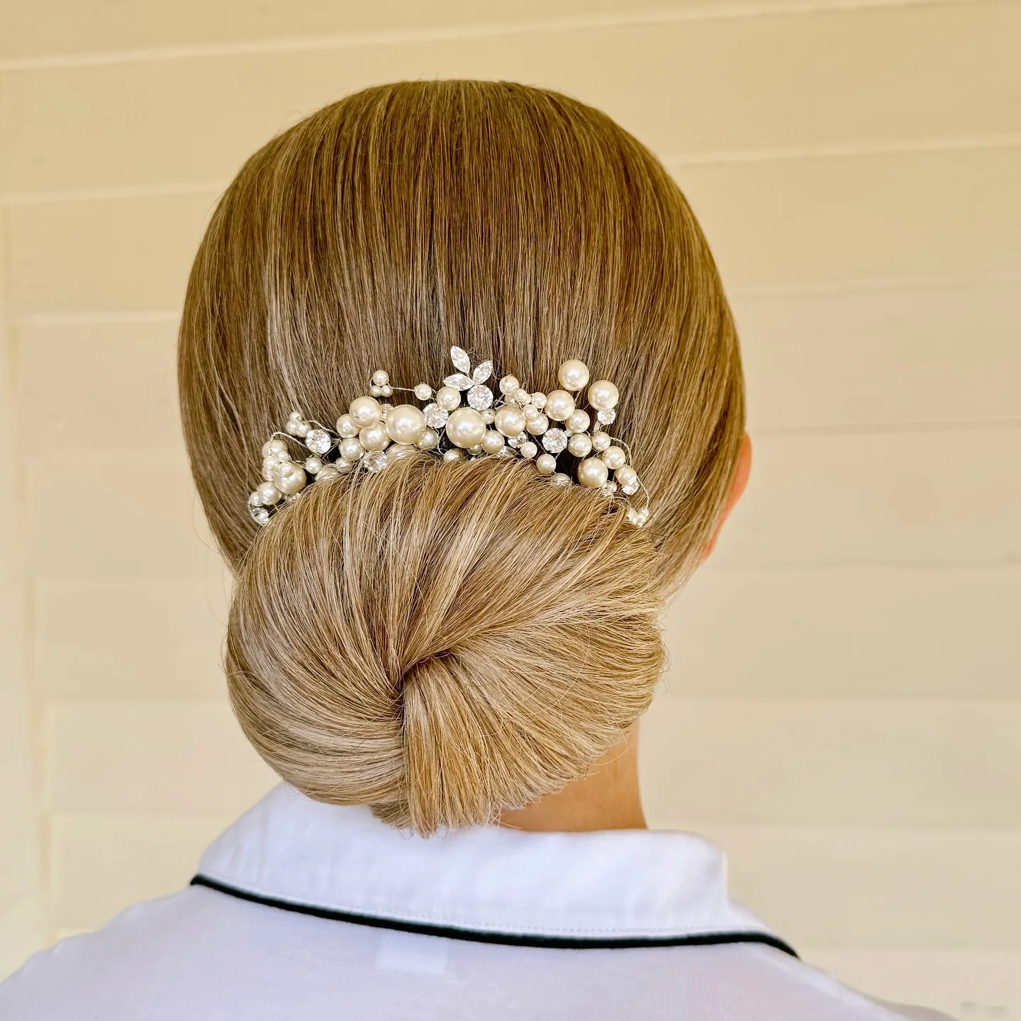chest wavy blonde bun shown as a wedding hairstyles ideas for long hair idea