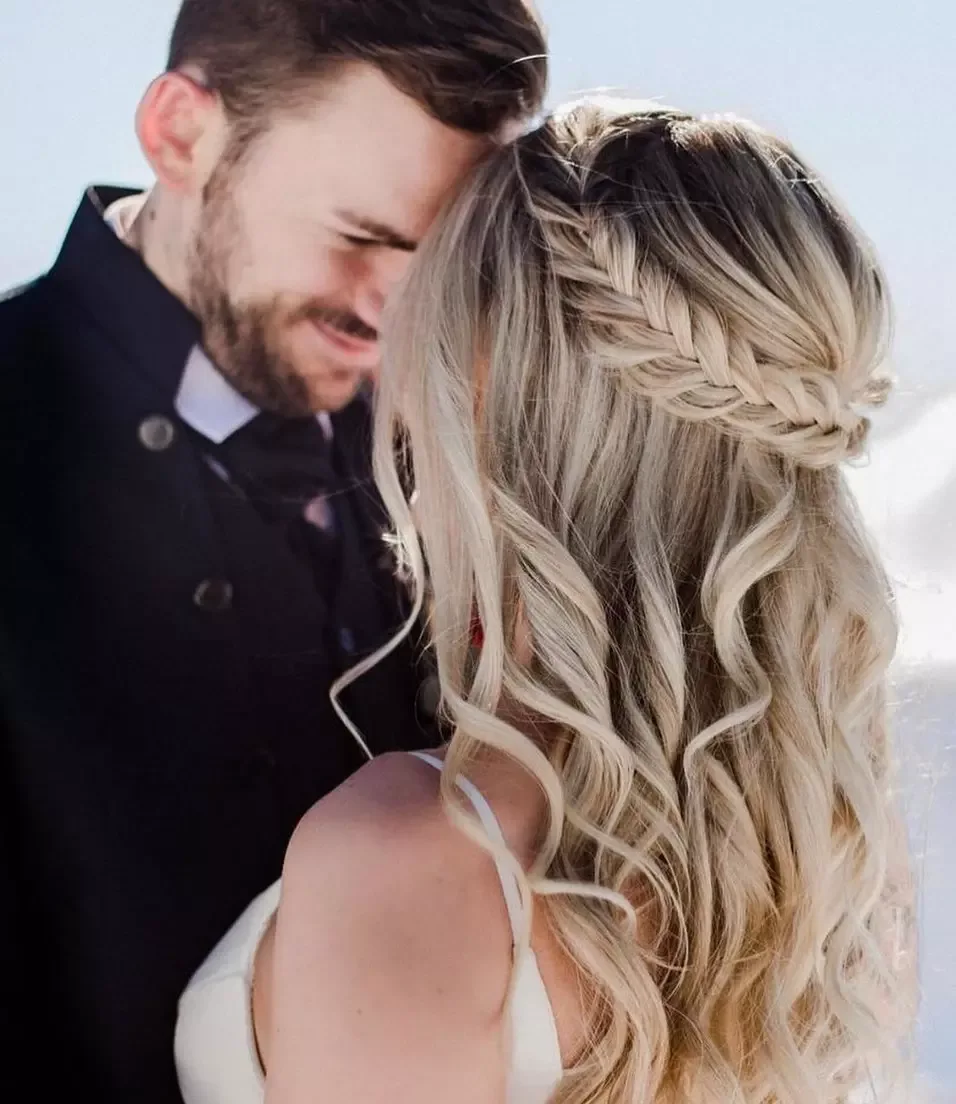 chest wavy brunette ponytail shown as a wedding hairstyles ideas for long hair idea, featuring wavy texture