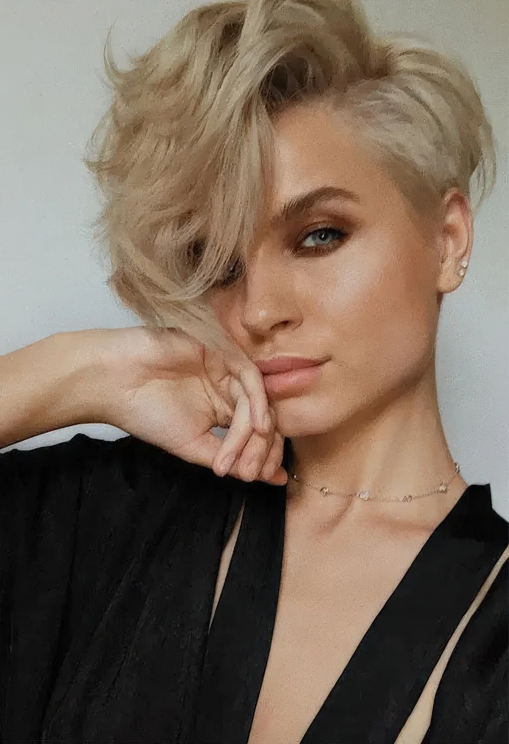 Wavy blonde long pixie with a lot of dimension and side part.