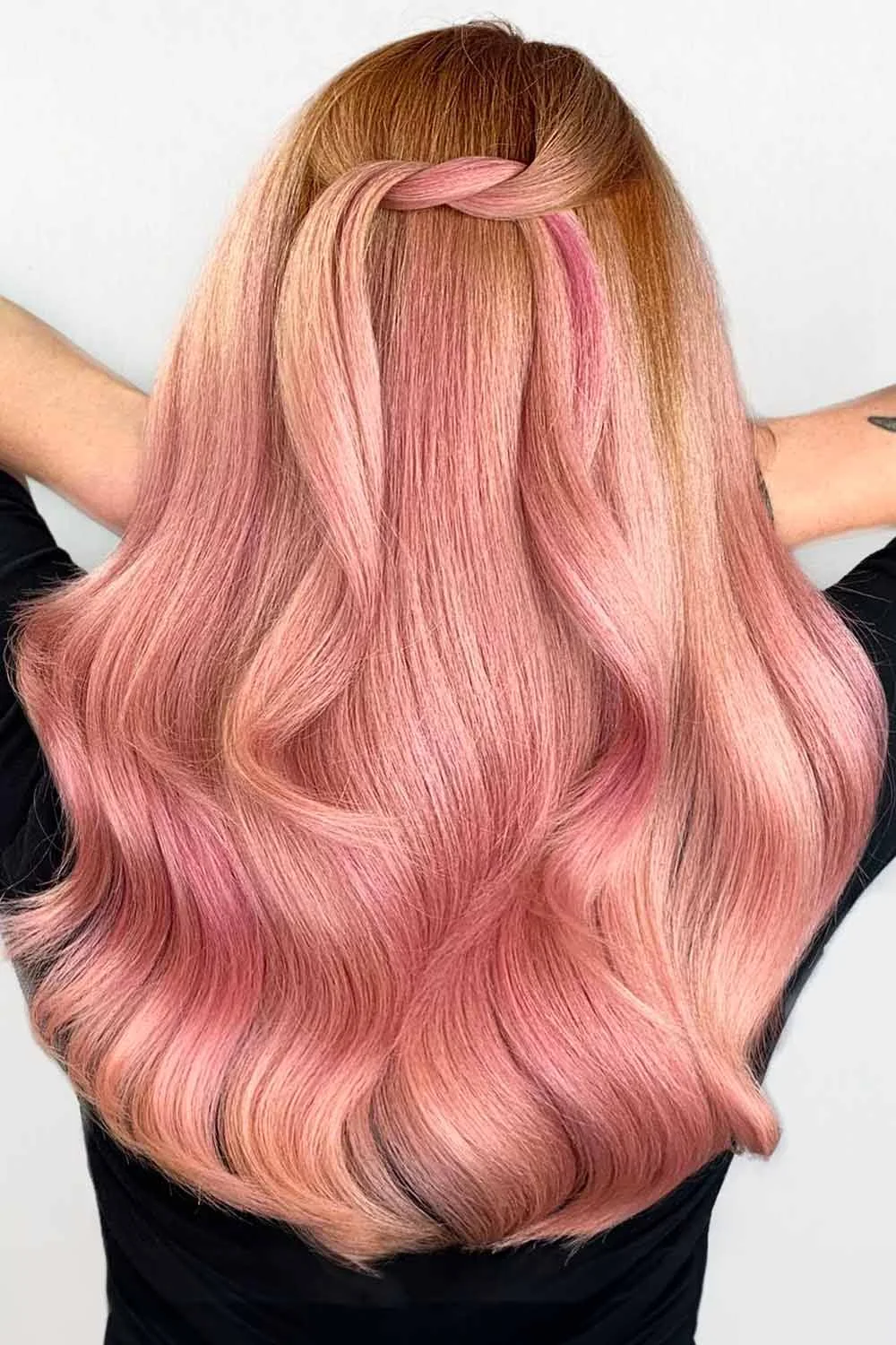 Back view of long rose-pink hair with a warmer top, pale pink lengths and broad smooth waves