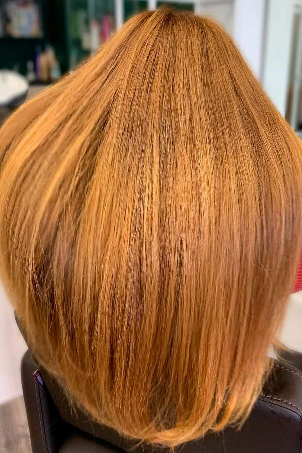 Back view of a straight blunt bob colored medium natural copper from roots to ends